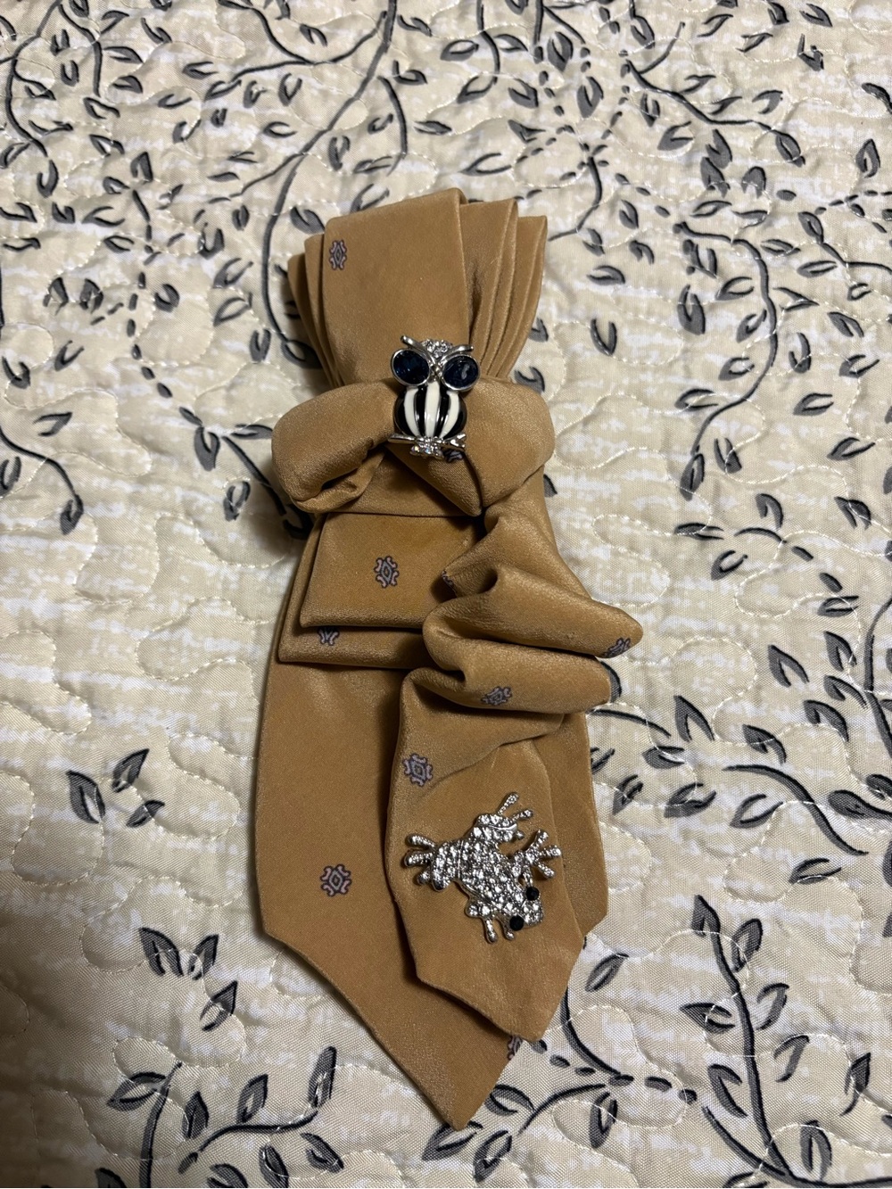 Female Tan Necktie with Decorative Brooches